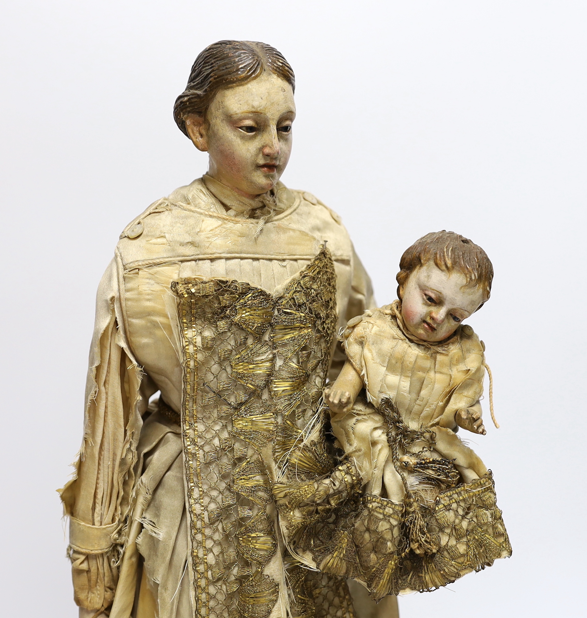 An 18th century Italian carved and painted wood model of Madonna and child, 45cm